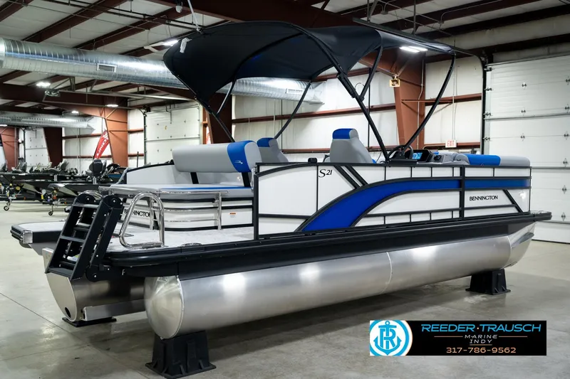 Slide: The Image of 2026 Bennington 21 SSB pontoon boat in showroom with canopy and seating. - 7