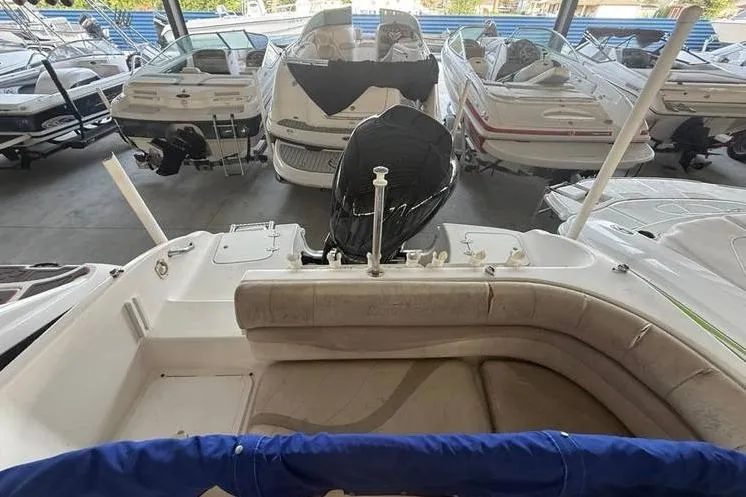 Slide: The Image of 2006 NauticStar 210 DC Sport Deck boat in showroom with other vessels. - 11