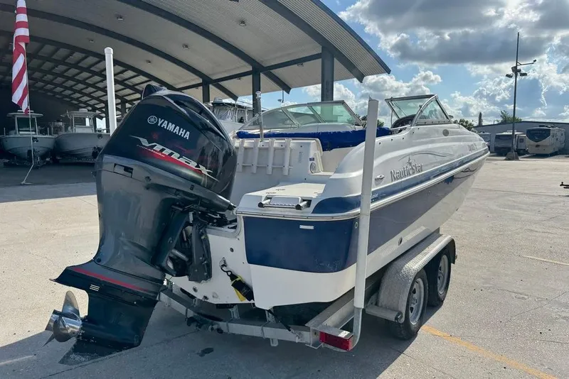 Slide: The Image of 2006 NauticStar 210 DC Sport Deck boat with Yamaha outboard motor on trailer. - 3