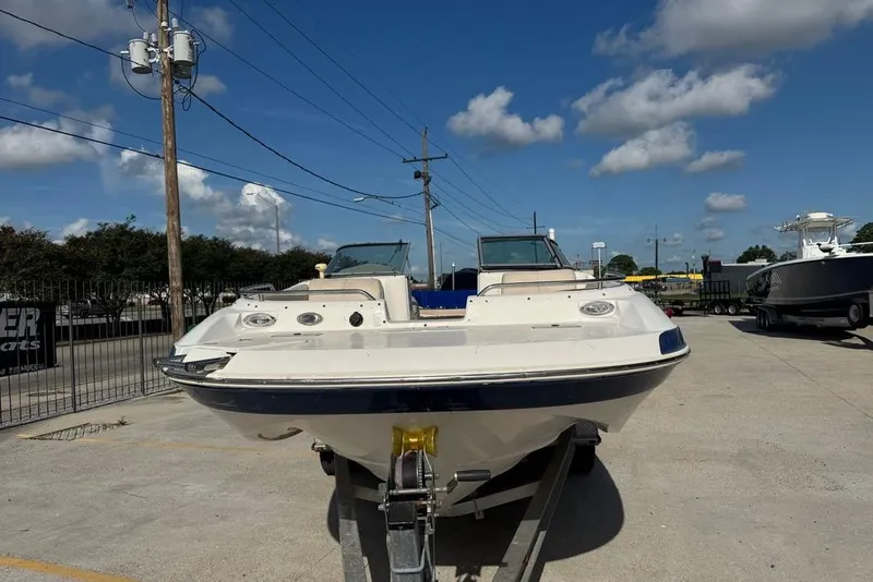 Slide: The Image of 2006 NauticStar 210 DC Sport Deck boat on trailer under blue sky. - 8