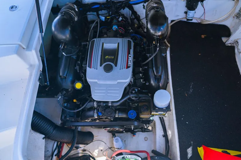 Slide: The Image of Engine compartment of a 2013 Sea Ray 240 Sundancer boat, showcasing the engine details. - 11