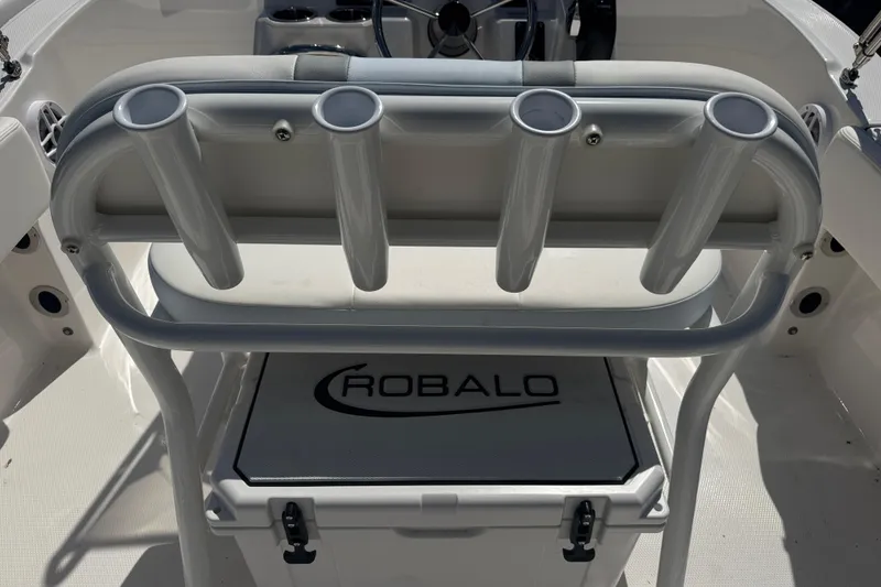 Slide: The Image of 2025 Robalo R180 Center Console boat interior with rod holders and storage compartment. - 3