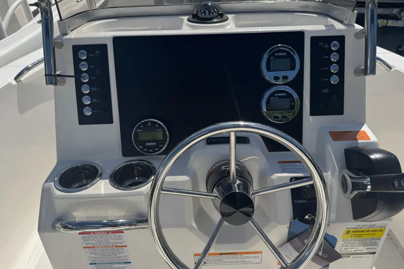 Slide: The Image of 2025 Robalo R180 Center Console dashboard with steering wheel and control panel. - 4