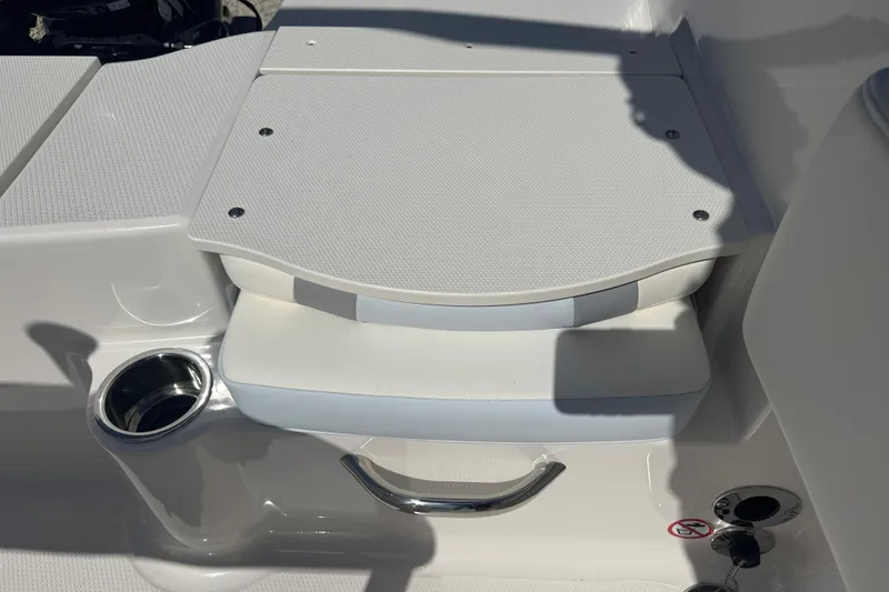 Slide: The Image of 2025 Robalo R180 Center Console boat seating area with cup holder and storage. - 8