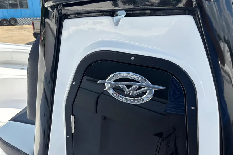 Slide: The Image of 2026 Tidewater 2500 Carolina Bay storage compartment with safety notice and equipment. - 13