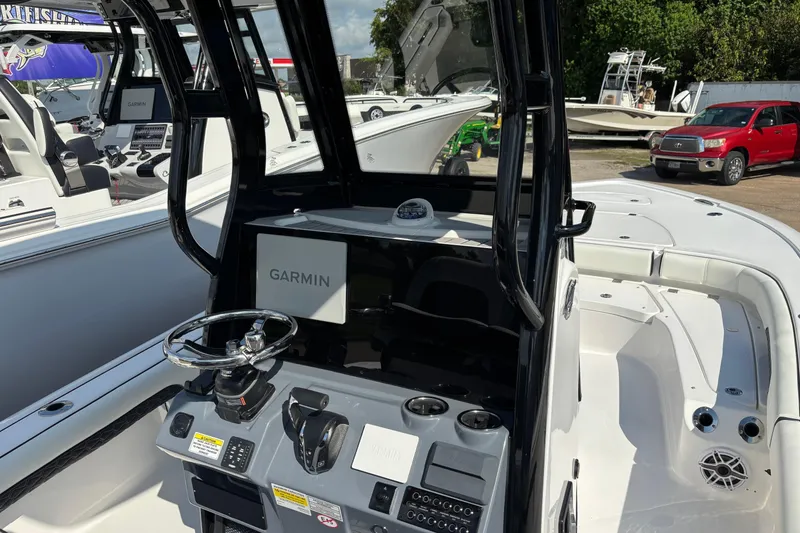 Slide: The Image of 2026 Tidewater 2500 Carolina Bay boat with Yamaha engine, displayed outdoors. - 3