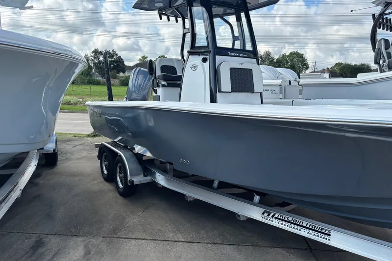 Slide: The Image of 2026 Tidewater 2500 Carolina Bay boat interior with rod holders and seating. - 6