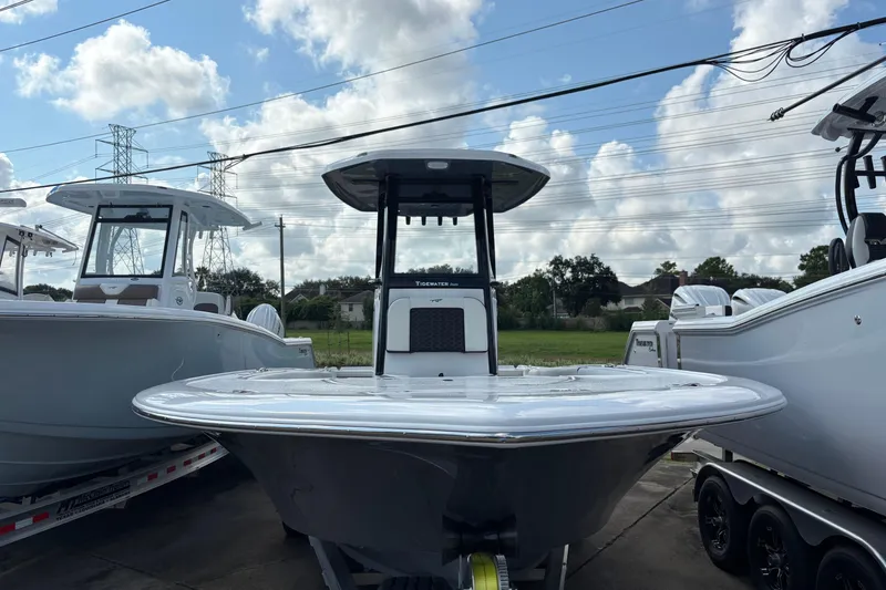 Slide: The Image of 2026 Tidewater 2500 Carolina Bay boat interior detail with cup holder and storage compartment. - 8