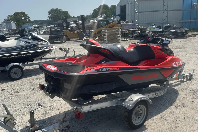 Slide: The Image of 2016 Sea-Doo RXT-X 300 jet ski on trailer in outdoor storage area. - 10