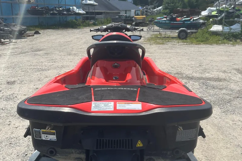 Slide: The Image of 2016 Sea-Doo RXT-X 300 jet ski, red, parked outdoors on gravel. - 7