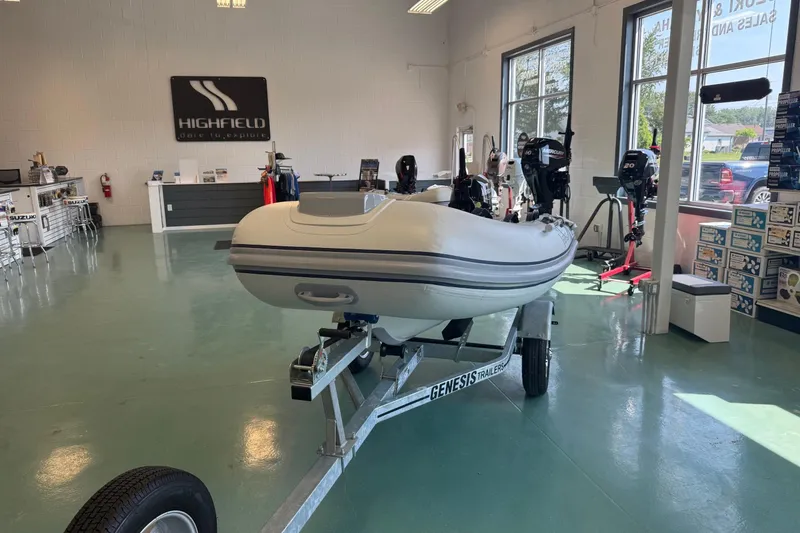 Slide: The Image of 2025 Highfield Classic 290 inflatable boat displayed in showroom on Genesis trailer. - 4