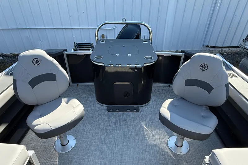 Slide: The Image of 2026 Tahoe Pontoon Geofish RF interior with two gray captain chairs and central console. - 7