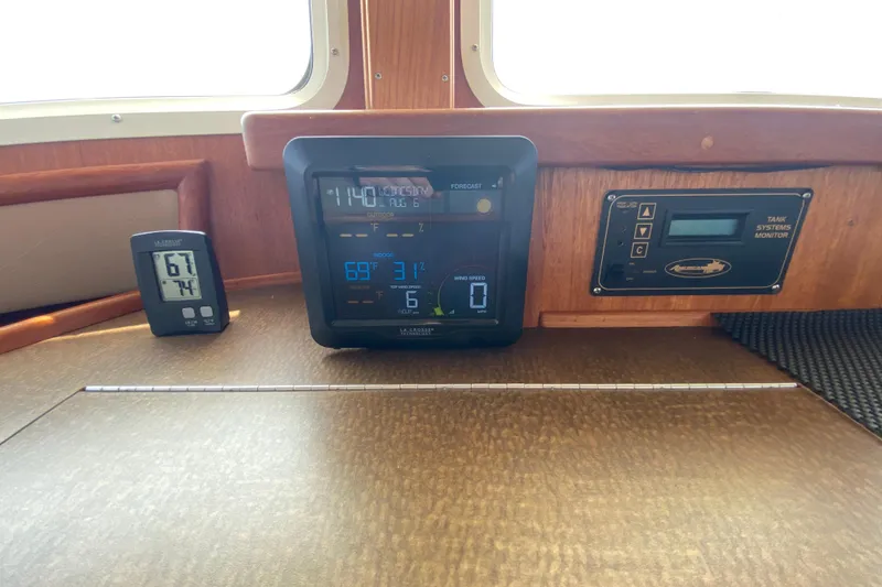 Slide: The Image of Control panel of a 2003 American Tug 34 with digital displays and monitoring systems. - 46