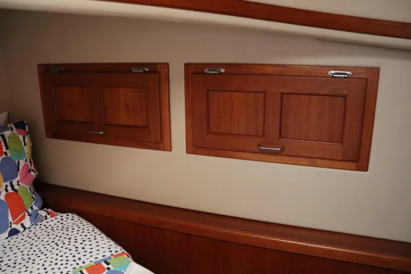 Slide: The Image of Interior of 2003 American Tug 34 with wooden cabinets and colorful bedding. - 55