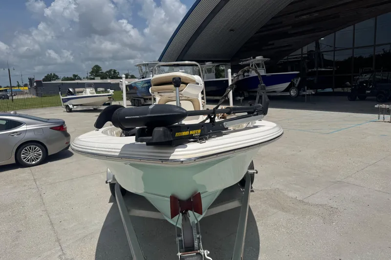 Slide: The Image of 2018 Key West 176 Bay Reef boat on trailer, parked outdoors under cloudy sky. - 4