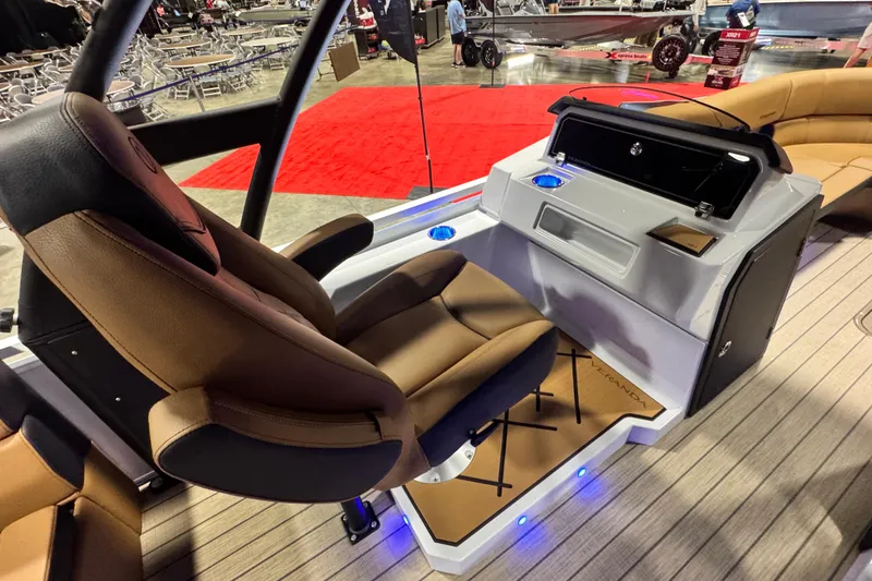 Slide: The Image of 2026 Veranda VX265DCVL boat interior with brown seating and modern console design. - 11