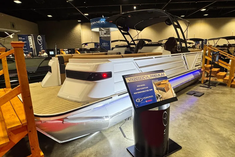 Slide: The Image of 2026 Veranda VX265DCVL pontoon boat displayed indoors with informational sign. - 3
