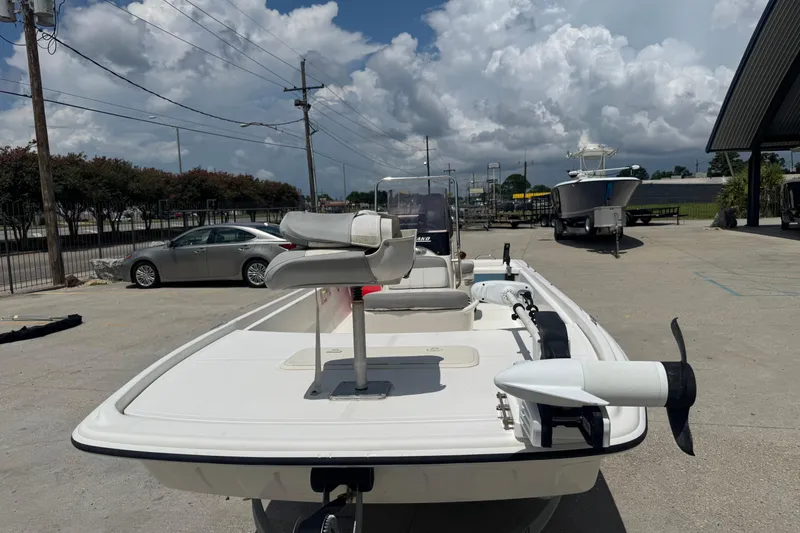 Slide: The Image of 2018 Mako Pro Skiff 17 CC boat parked outdoors under cloudy sky. - 6