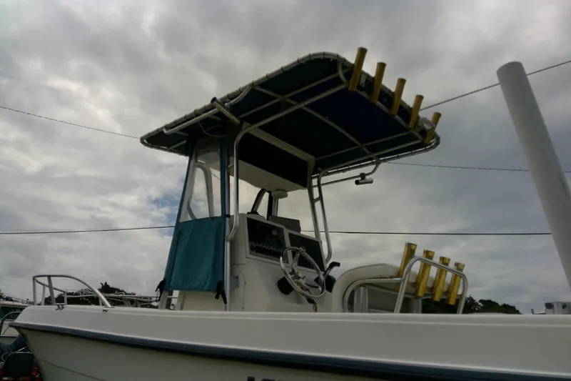 Slide: The Image of 2001 Key West boat with canopy and rod holders under cloudy sky. - 10