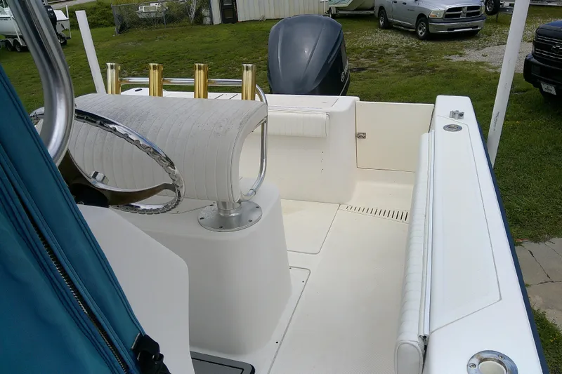 Slide: The Image of 2001 Key West boat interior with steering wheel, seating, and rod holders. - 12