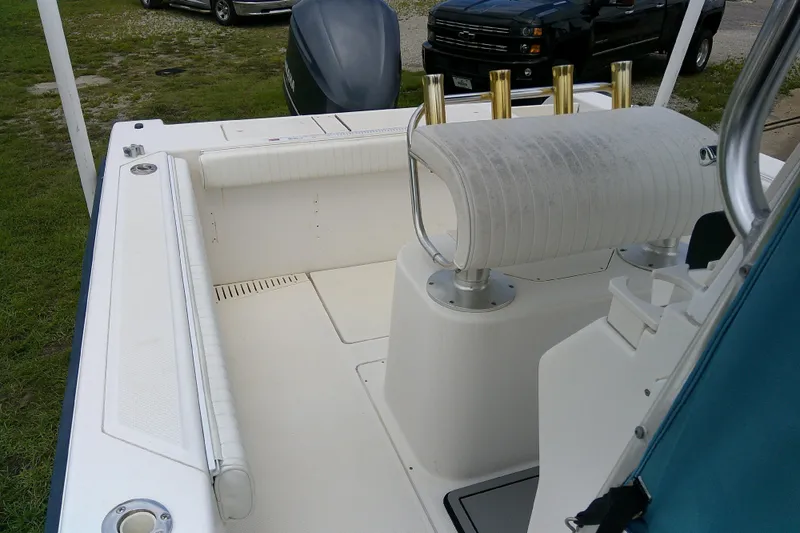 Slide: The Image of 2001 Key West boat interior with seating and rod holders, parked on grass. - 13