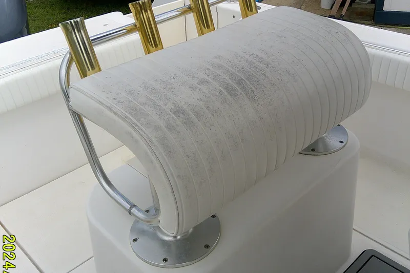 Slide: The Image of Key West 2300 CC 2001 boat seat with rod holders, showing wear and discoloration. - 15