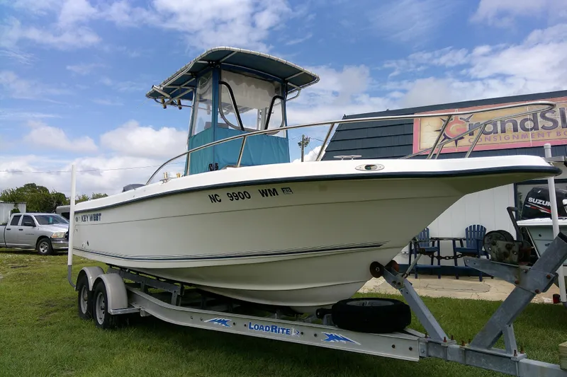 Slide: The Image of 2001 Key West boat on trailer, parked outdoors under a cloudy sky. - 3