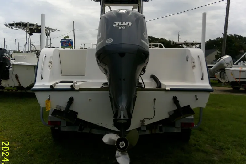 Slide: The Image of 2001 Key West boat with 300 HP outboard motor, parked on grass. - 8