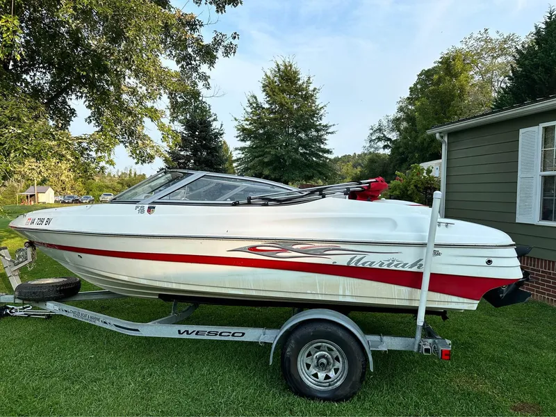 Slide: The Image of 2007 Mariah FS18 boat on trailer, parked on grass beside a house. - 4