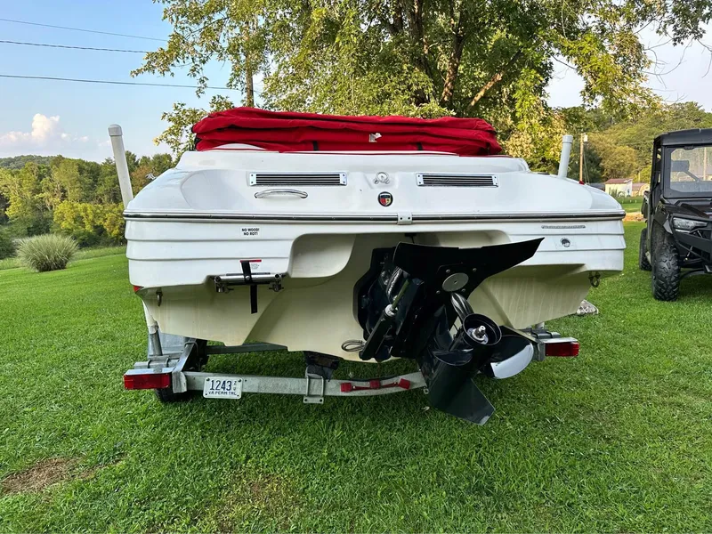 Slide: The Image of 2007 Mariah FS18 boat with red cover on grassy area, rear view. - 6