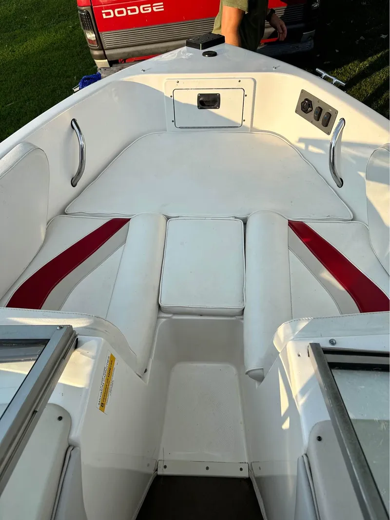 Slide: The Image of 2007 Mariah FS18 boat interior with white and red seating, Dodge vehicle in background. - 8