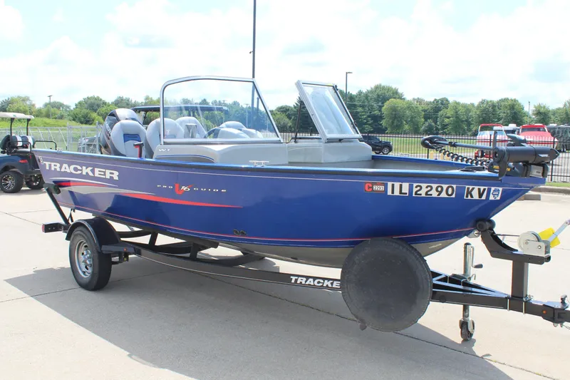 Slide: The Image of 2016 Tracker Pro Guide V-16 WT boat on trailer, parked outdoors. - 3