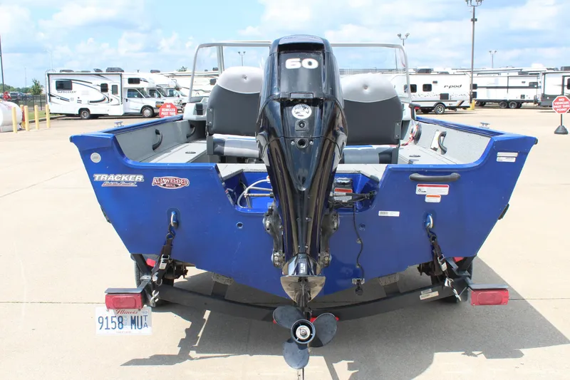 Slide: The Image of 2016 Tracker Pro Guide V-16 WT boat with 60 HP outboard motor, parked on trailer. - 6