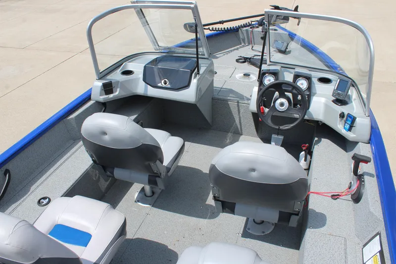Slide: The Image of 2016 Tracker Pro Guide V-16 WT boat interior with dual seats and steering console. - 7