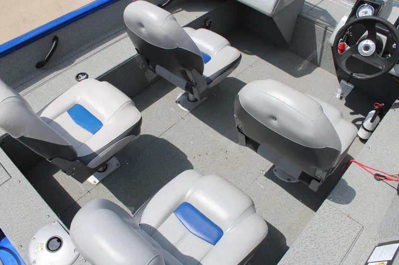 Slide: The Image of 2016 Tracker Pro Guide V-16 WT boat interior with four gray and blue seats. - 8