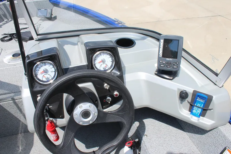 Slide: The Image of 2016 Tracker Pro Guide V-16 WT boat dashboard with steering wheel and Lowrance fish finder. - 9