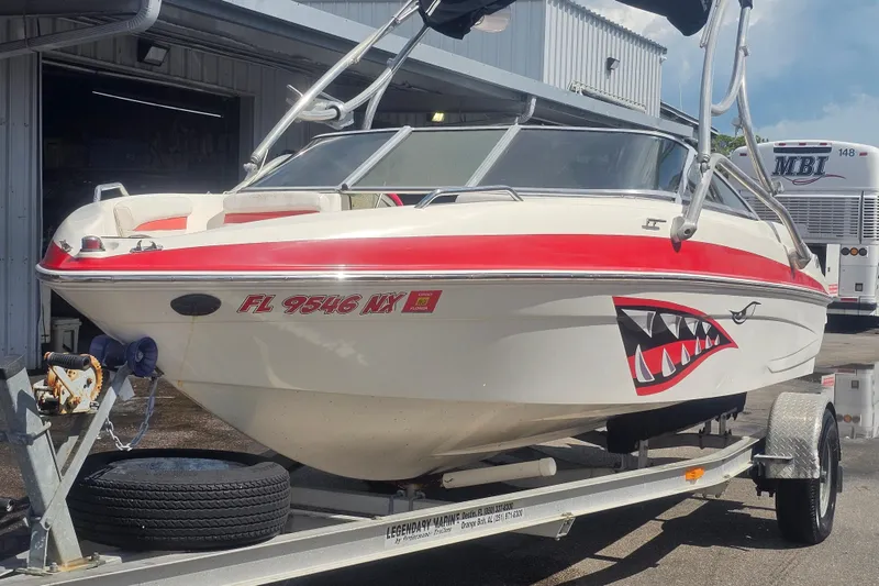 The Image of 2008 Glastron GT 205 boat with shark mouth decal on trailer. - 0