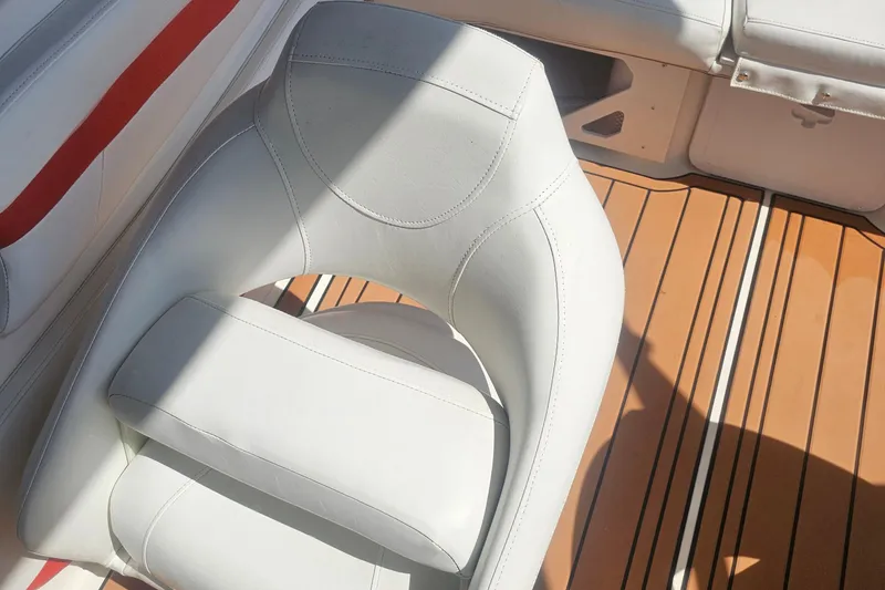 Slide: The Image of White leather seat on 2008 Glastron GT 205 boat with wooden deck. - 12