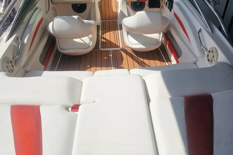 Slide: The Image of 2008 Glastron GT 205 boat interior with white and red seating, wood-style flooring. - 13
