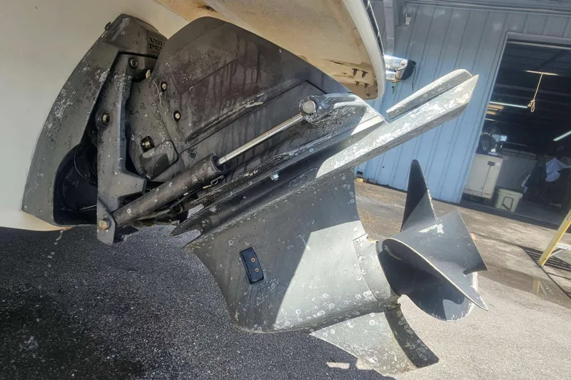 Slide: The Image of Close-up of a 2008 Glastron GT 205 boat's propeller and outdrive in a garage setting. - 17