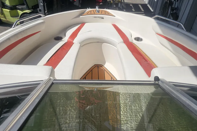 Slide: The Image of 2008 Glastron GT 205 boat interior with red and white seating, viewed from the windshield. - 9