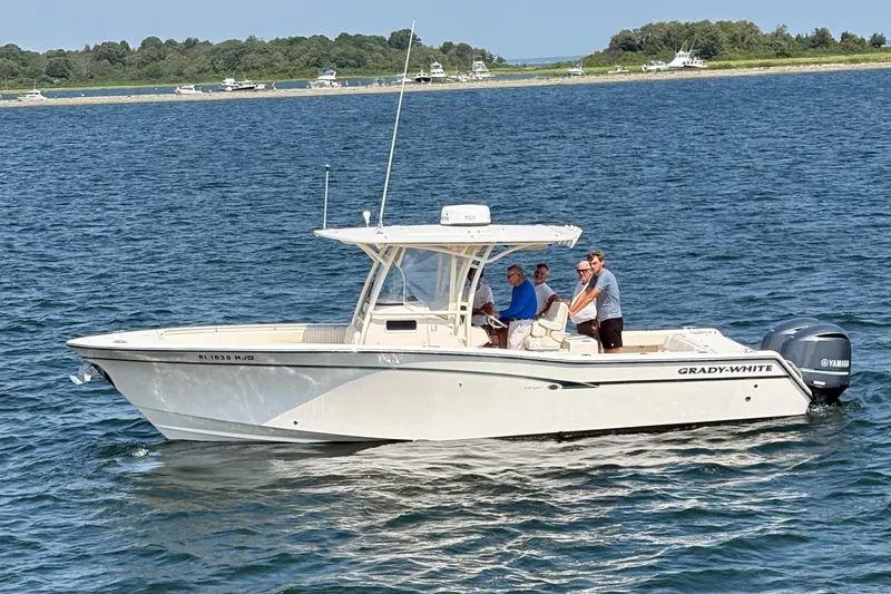 The Image of 2013 Grady-White Canyon 306 boat on water with passengers, Yamaha engines visible. - 0