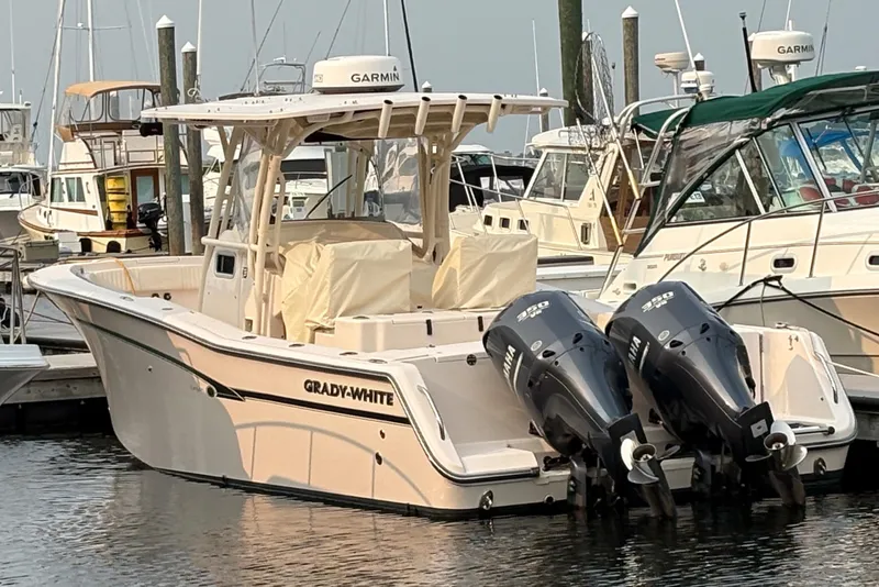 Slide: The Image of 2013 Grady-White Canyon 306 boat docked with twin Yamaha outboard engines. - 10