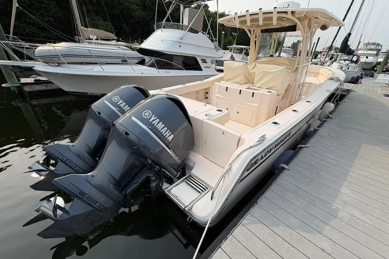 Slide: The Image of 2013 Grady-White Canyon 306 boat with twin Yamaha engines docked at marina. - 11