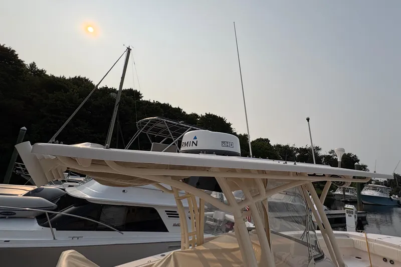 Slide: The Image of 2013 Grady-White Canyon 306 boat docked under a hazy sun. - 12