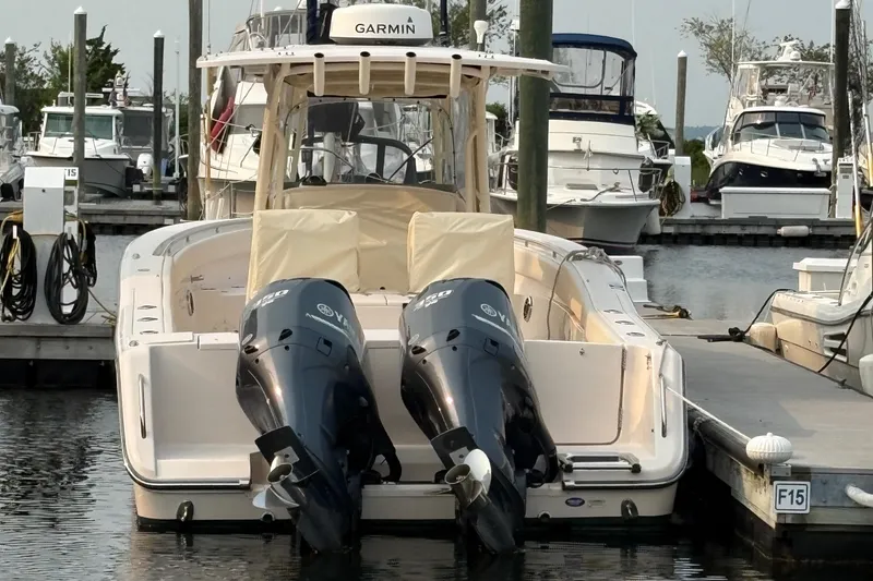 Slide: The Image of 2013 Grady-White Canyon 306 boat docked with twin Yamaha outboard engines. - 13