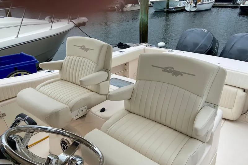 Slide: The Image of 2013 Grady-White Canyon 306 boat interior with plush seating and steering wheel. - 15