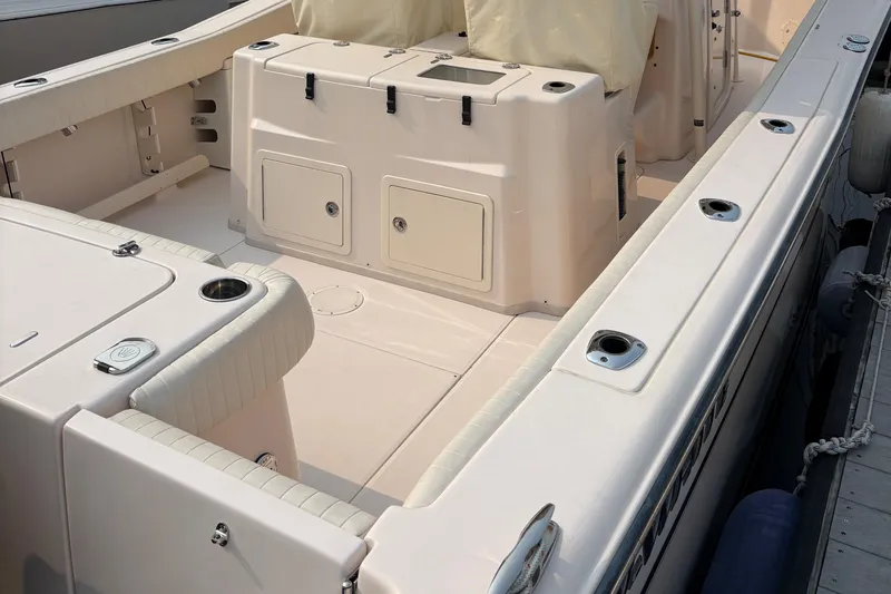 Slide: The Image of 2013 Grady-White Canyon 306 boat interior with seating and storage compartments. - 17