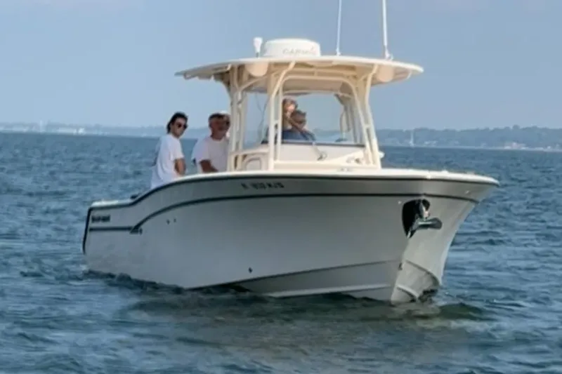 Slide: The Image of 2013 Grady-White Canyon 306 boat with passengers on open water. - 2