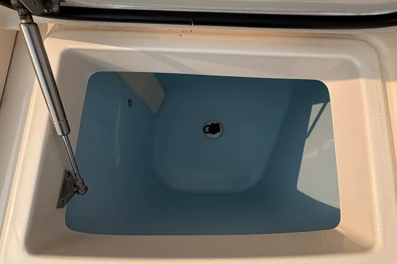 Slide: The Image of Livewell compartment on a 2013 Grady-White Canyon 306 boat, open and empty. - 20